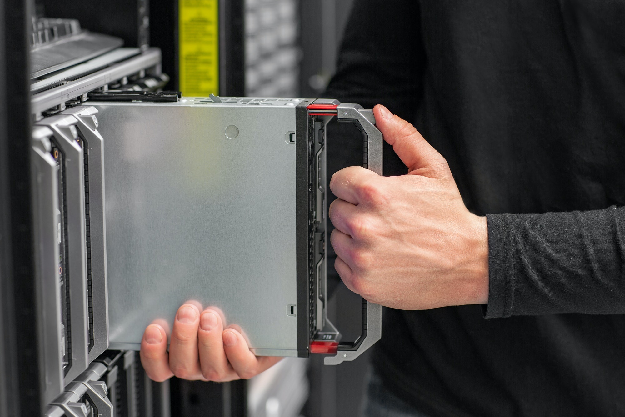 Close-up of IT consultant install blade Server in datacenter